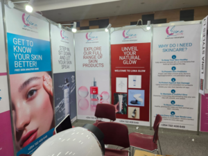 Exhibition setup with banners promoting skincare awareness, product benefits, and free skin analysis.