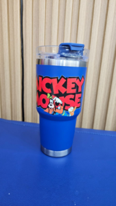Blue insulated tumbler with “MICKEY MOUSE” text and cartoon characters Goofy and Donald Duck.