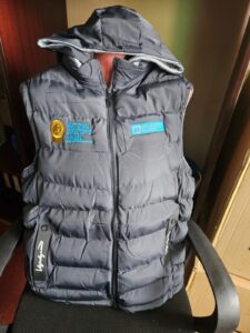 Dark gray sleeveless jacket embroidered with National Director’s Award emblem and SOS Children’s Villages logo, showcasing volunteer recognition branding.