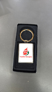 Rectangular metallic keychain in black gift box with Baystar Energies logo featuring red and green flame design and text.